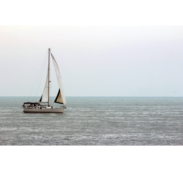 Sailing boat on the sea under the sea wall mural - TenStickers